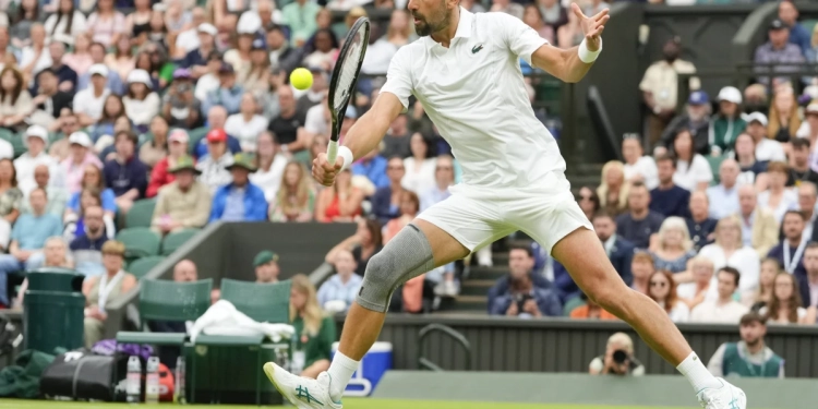 Novak Djokovic wins his first match at Wimbledon with a sleeve on his surgically repaired knee